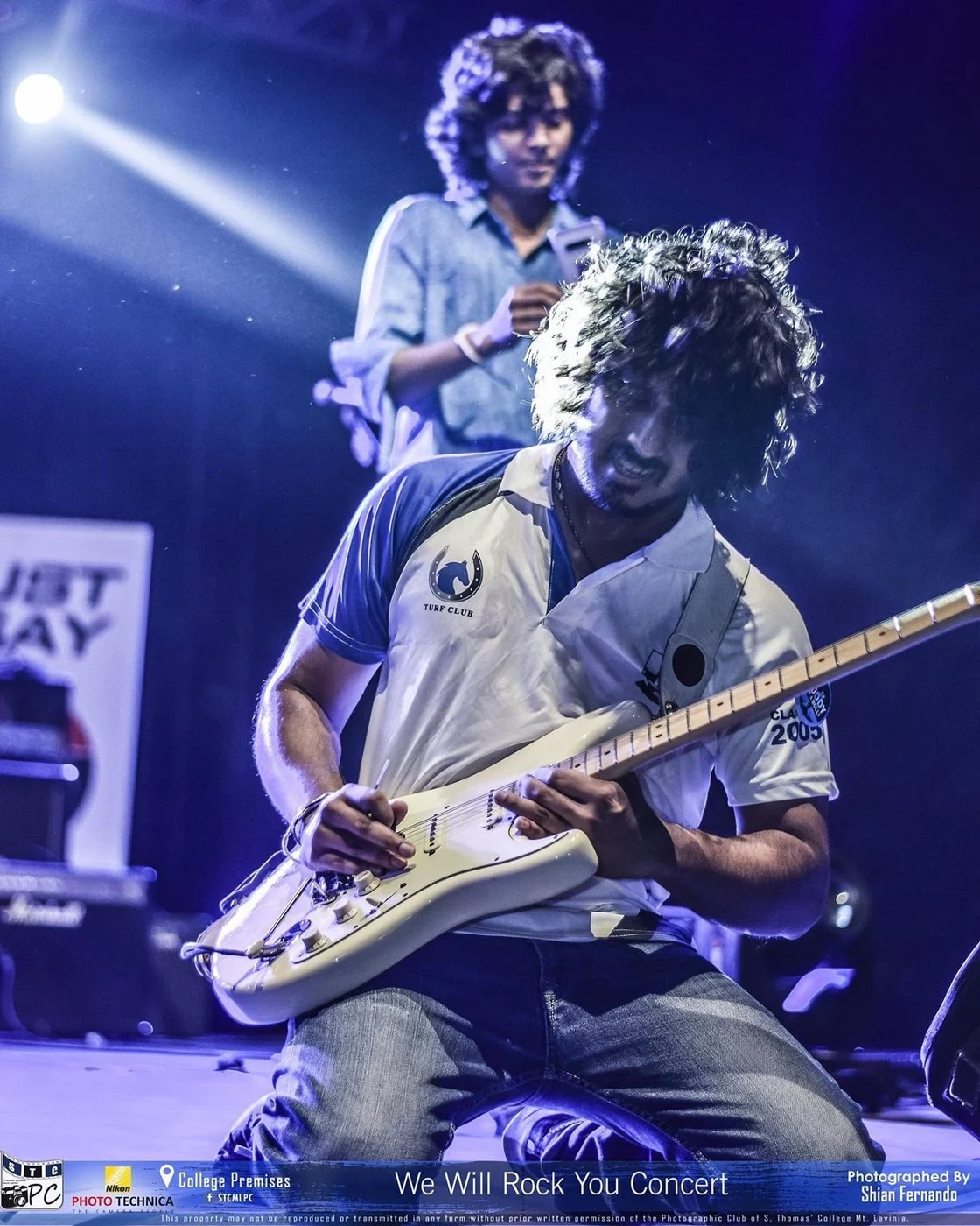 Wagon Park guitarist performing under blue stage lights