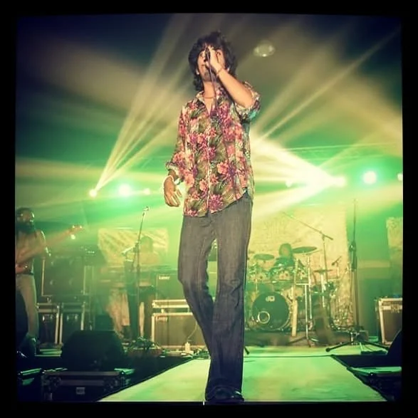Wagon Park vocalist under green concert lighting
